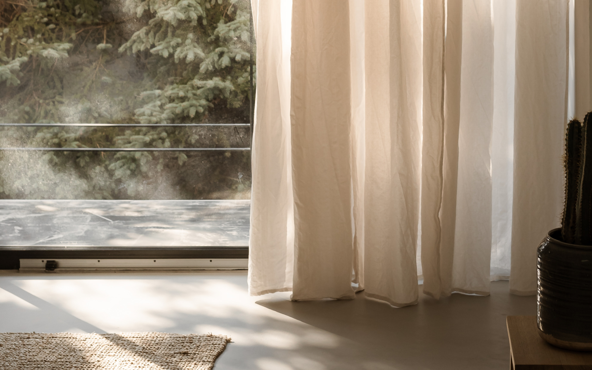 Sunlit low-toxin wellness-inspired home interior with natural linen curtains