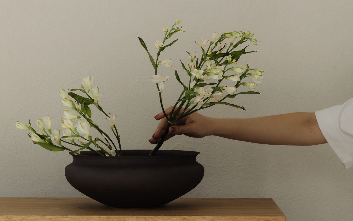 Intentional low-toxin home styling with natural wood and calming floral decor